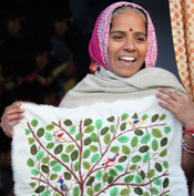 

   One Village producer   
   holding product in work   
.
